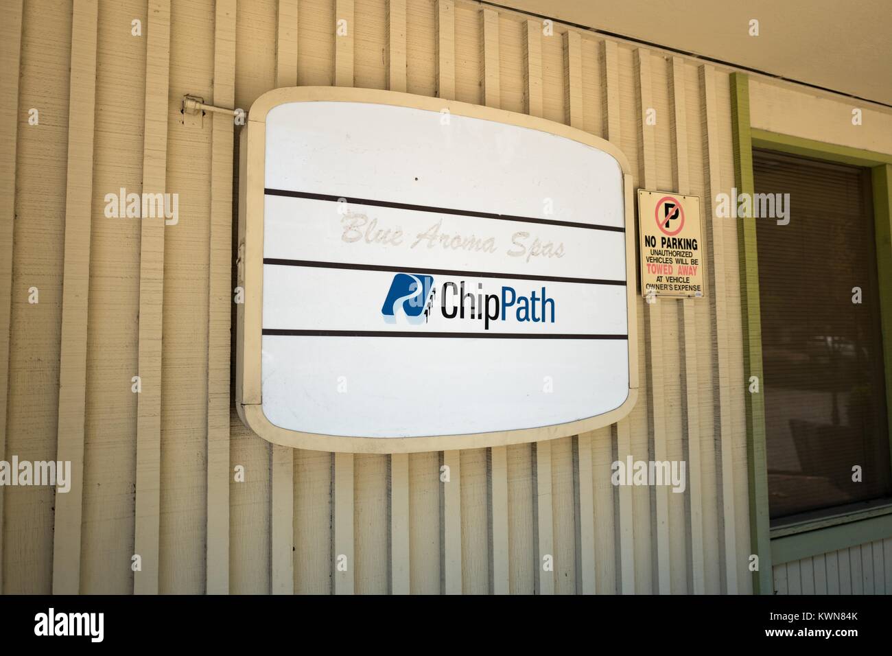 Signage for Chip Path Design Systems, a software company located near the Apple Park, known colloquially as 'The Spaceship', the new headquarters of Apple Inc in the Silicon Valley town of Cupertino, California, July 25, 2017. Since Apple's announcement of its new headquarters, commercial real estate prices near the headquarter's site have increased dramatically, and several new developments have been planned. Stock Photo