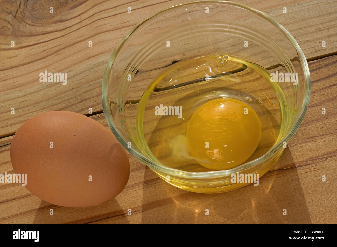 Brown chicken egg in shell and broken reading for cooking. Stock Photo