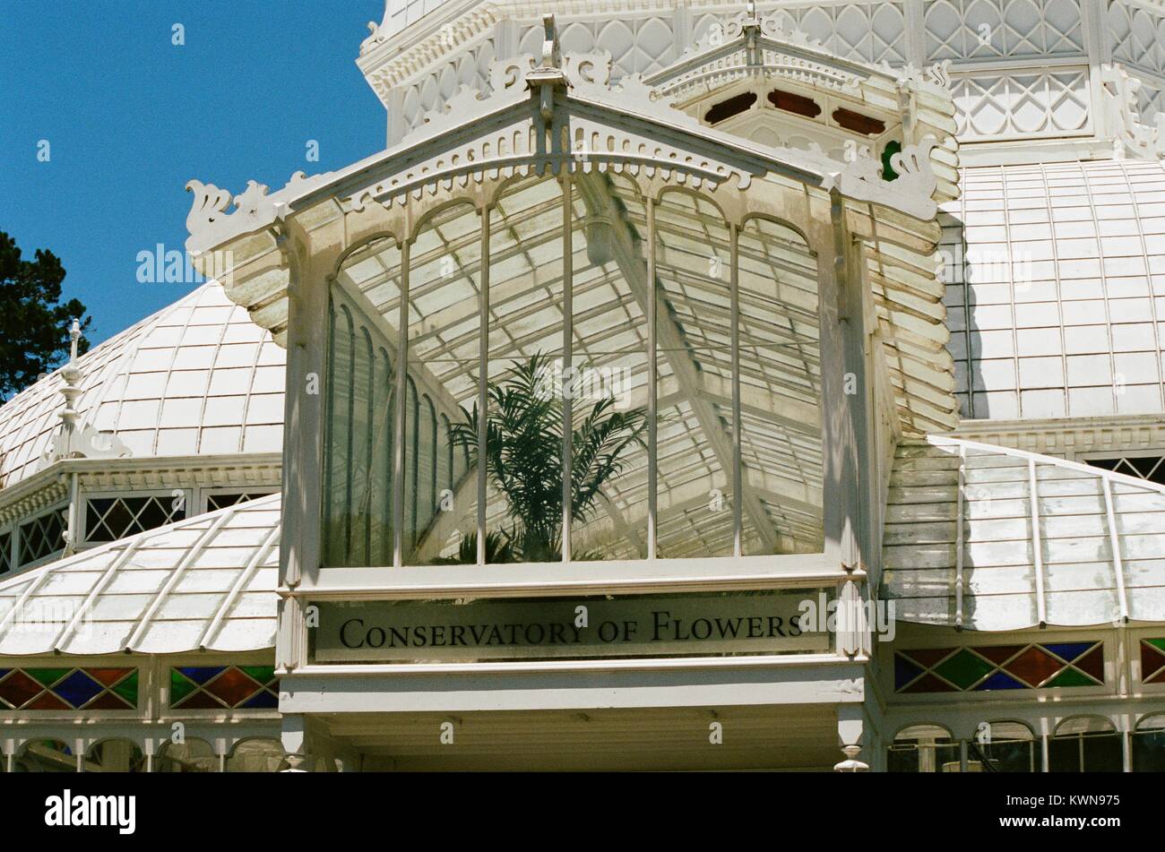 Closeup of the front entrance to the Conservatory of Flowers, a Victorian-era greenhouse and flower conservatory in Golden Gate Park, San Francisco, California, with stained glass and text reading Conservatory of Flowers, July 11, 2017. Stock Photo