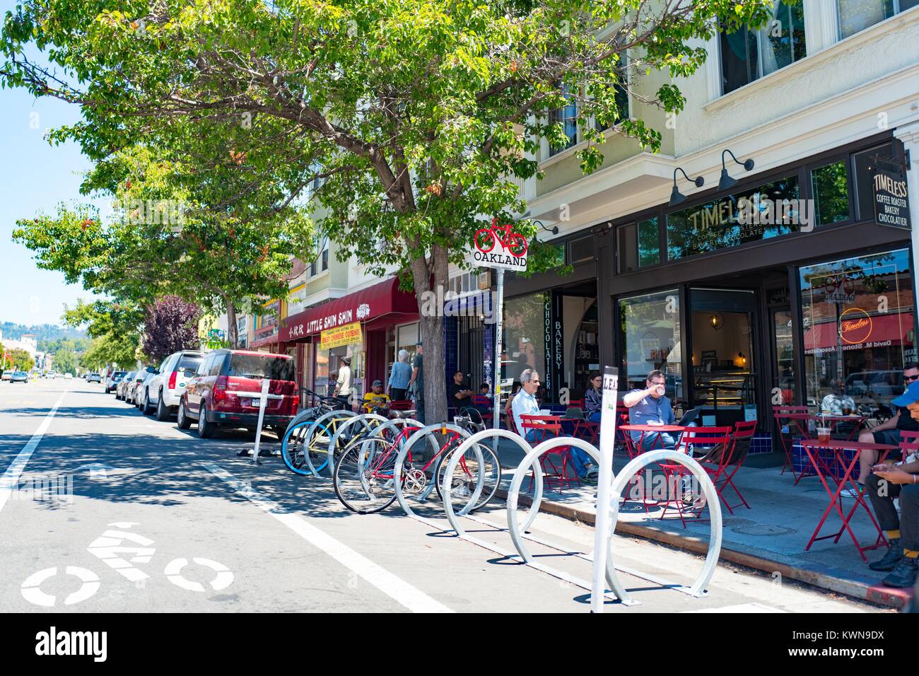 People dine outdoors at a coffee shop on trendy Piedmont Avenue in
