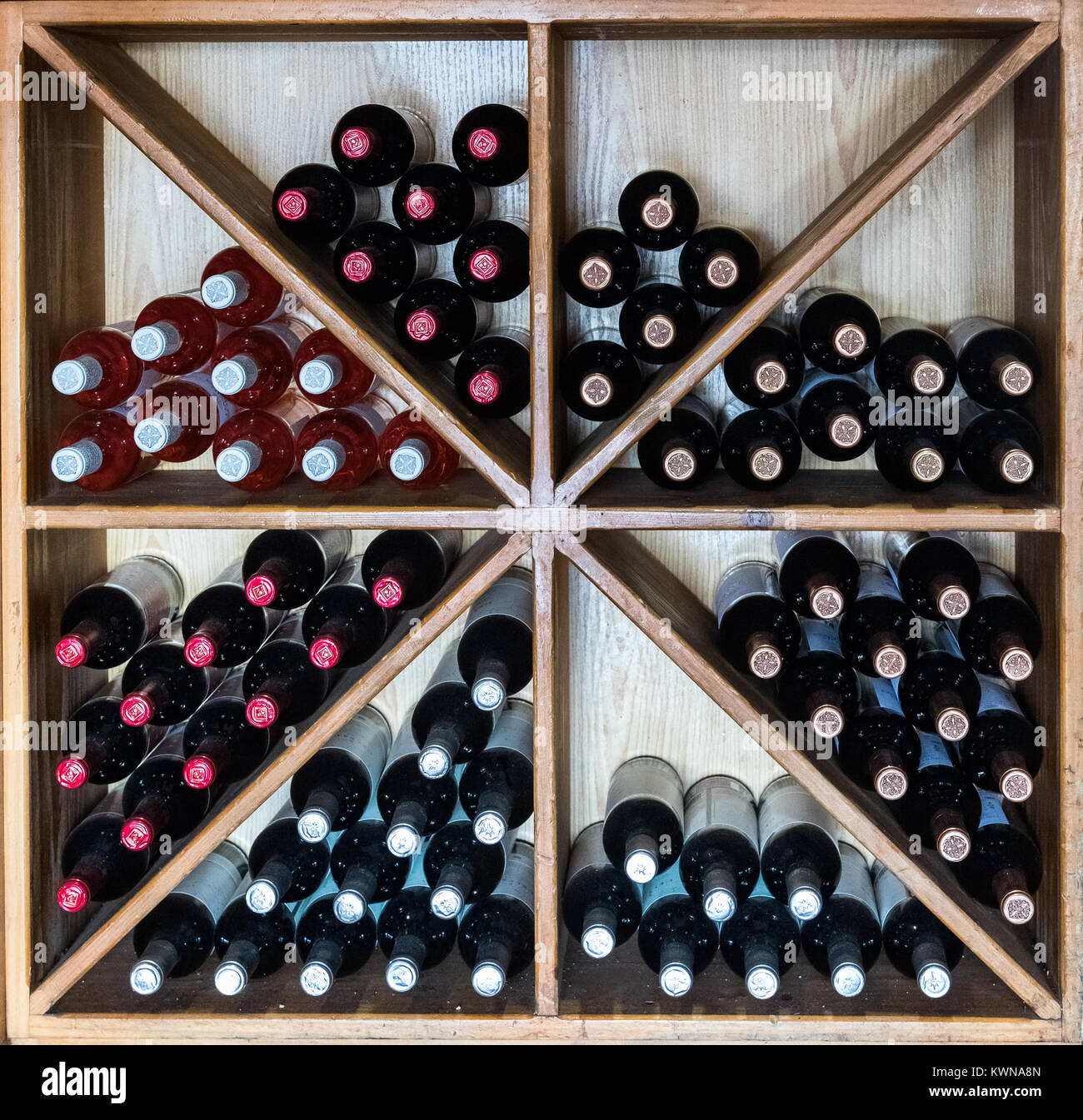 Puerto de Mogan, Gran Canaria in Spain - December 16, 2017: wine bottles stored in a rack at a restaurant, square image Stock Photo