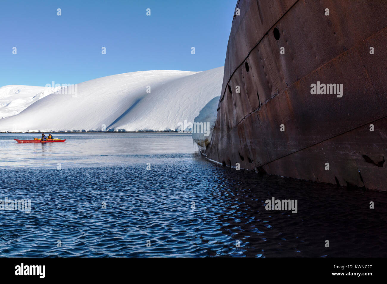 Tourists in sea kayaks visit Norweigan whaling shipwreck; Gouvenoren; Enterprise Island; Antarctica Stock Photo