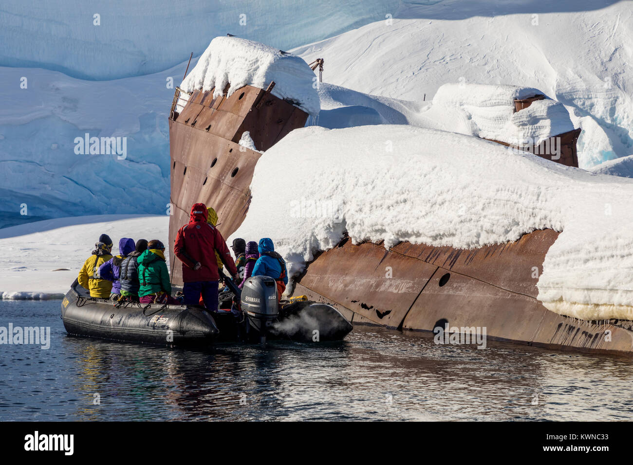Tourists in Zodiac boat visit Norweigan whaling shipwreck; Gouvenoren; Enterprise Island; Antarctica Stock Photo