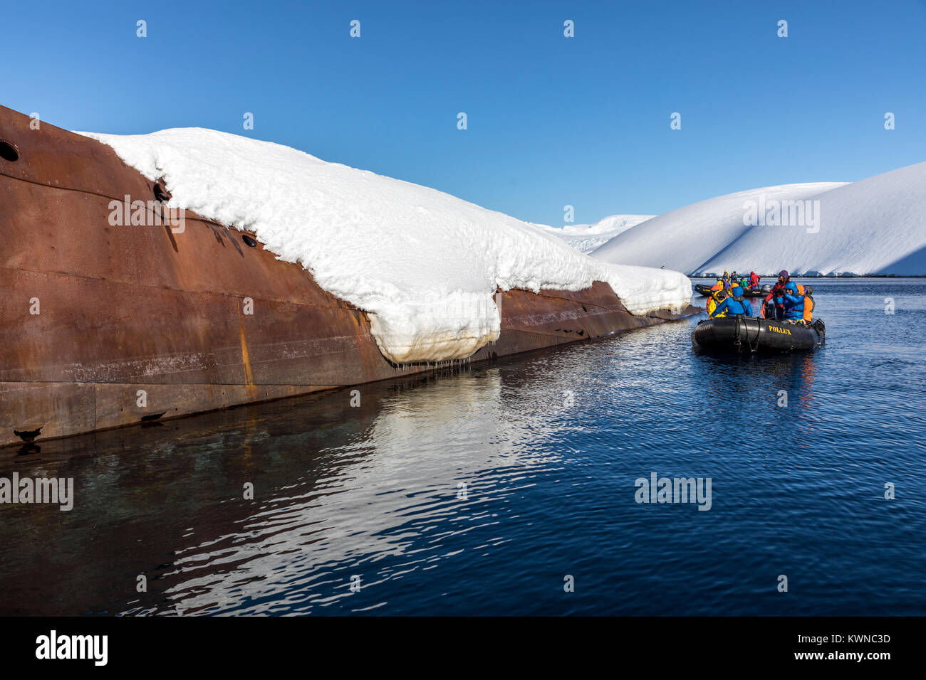 Tourists in Zodiac boat visit Norweigan whaling shipwreck; Gouvenoren; Enterprise Island; Antarctica Stock Photo