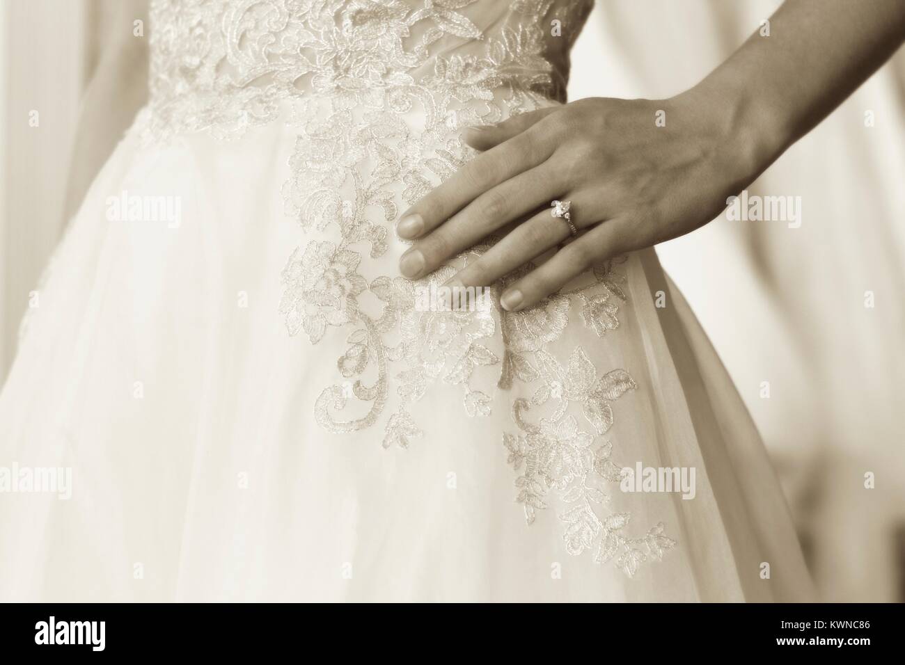 Engagement ring closeup with bridal gown Stock Photo