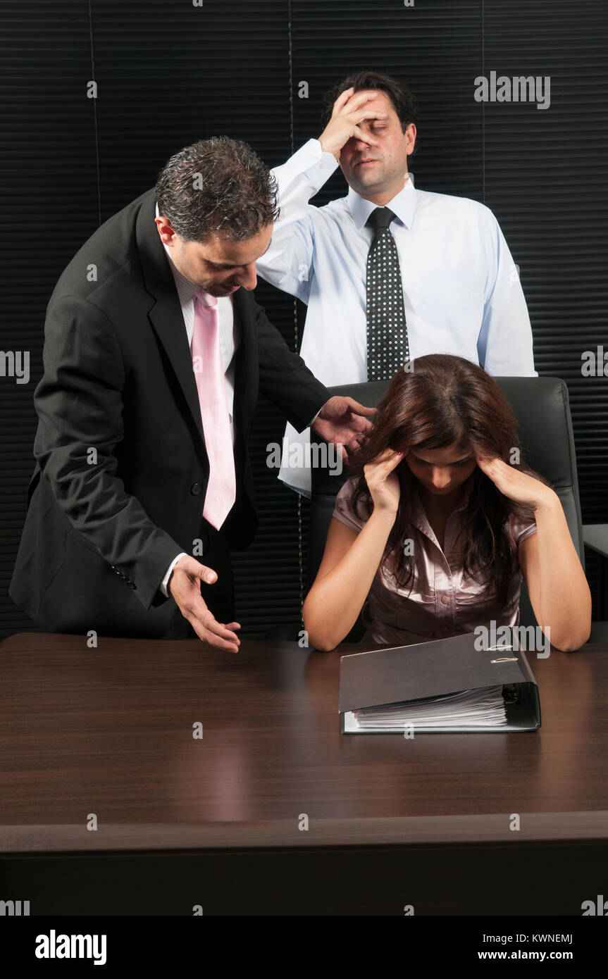 Businessman telling offf a female employee at work Stock Photo
