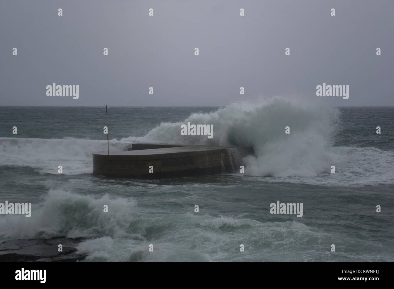 Waves breaking on the shore of the Mediterranean sea in winter Stock Photo