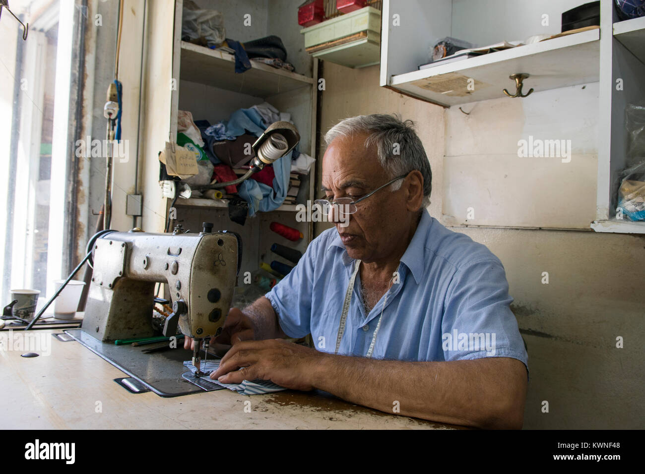 Tailor working with a sewing machine Stock Photo