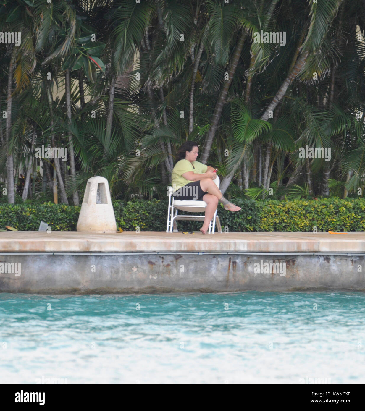 MIAMI BEACH, FL - JUNE 11:  (EXCLUSIVE COVERAGE) Rosie O'Donnell (wearing no make up and a bandage on her foot.)  Enjoys her day as she sits on her dock texting from her estate in Miami. Roseann "Rosie" O'Donnell (born March 21, 1962) is an American stand-up comedienne, actress, singer, author and media personality. She has also been a magazine editor and continues to be a celebrity blogger, LGBT rights activist; television producer and collaborative partner in the LGBT family vacation company R Family Vacations.   On June 11, 2011 in Miami Beach, Florida    People:  Rosie O'Donnell Stock Photo