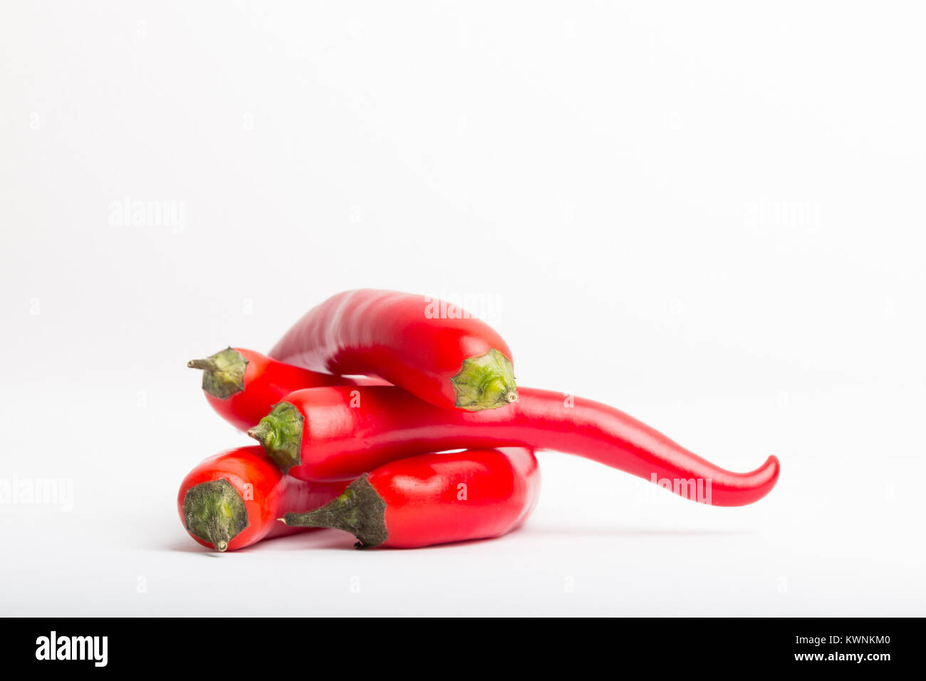 isolated red chili peppers on a white background Stock Photo - Alamy