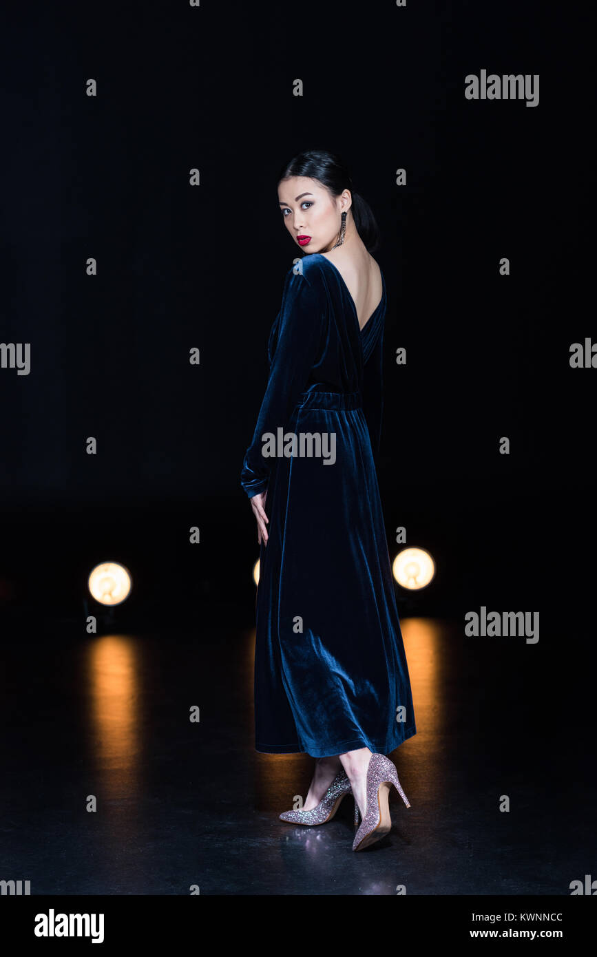 side view of asian woman in maxi dress 