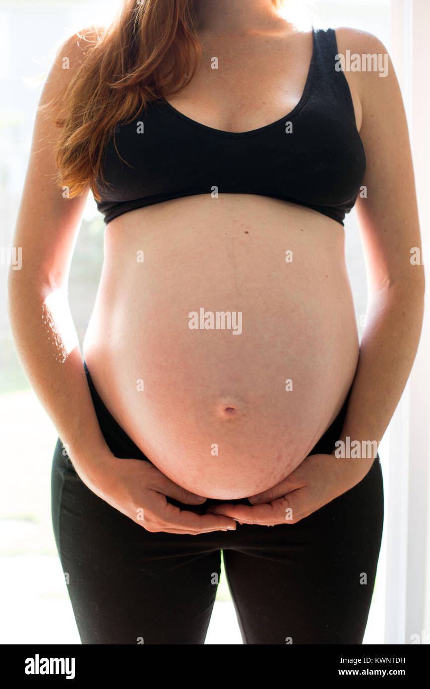 An American mother who is eight months pregnant. Stock Photo