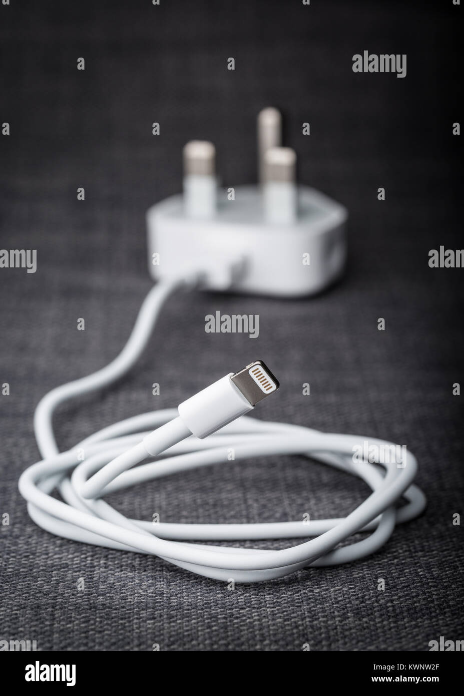 an iPhone cable with a UK plug for charging Stock Photo