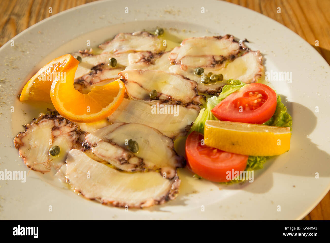 Octopus carpaccio with capers in olive oi, restaurant, Croatia Stock Photo