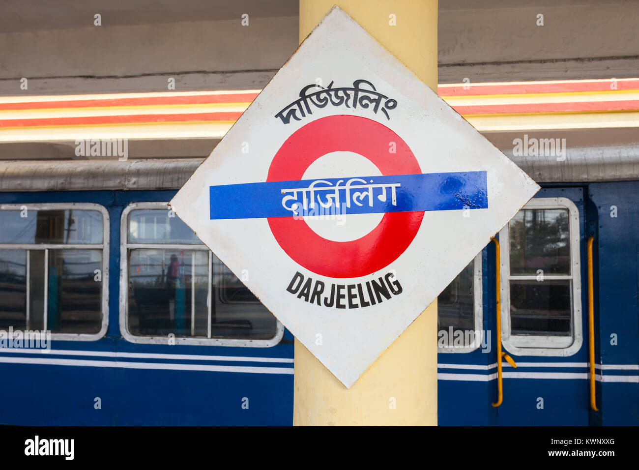 Darjeeling railway station sign and train on background in Darjeeling, India Stock Photo
