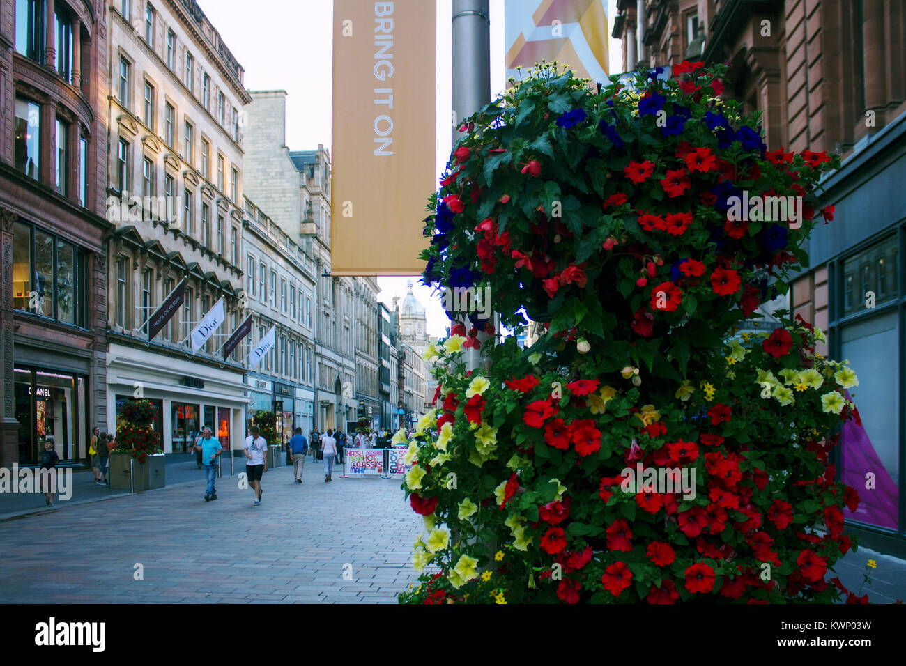 Looking up Buchanan Street during the XX Commonwealth Games, Glasgow, Scotland, with a display of flowers in foreground Stock Photo