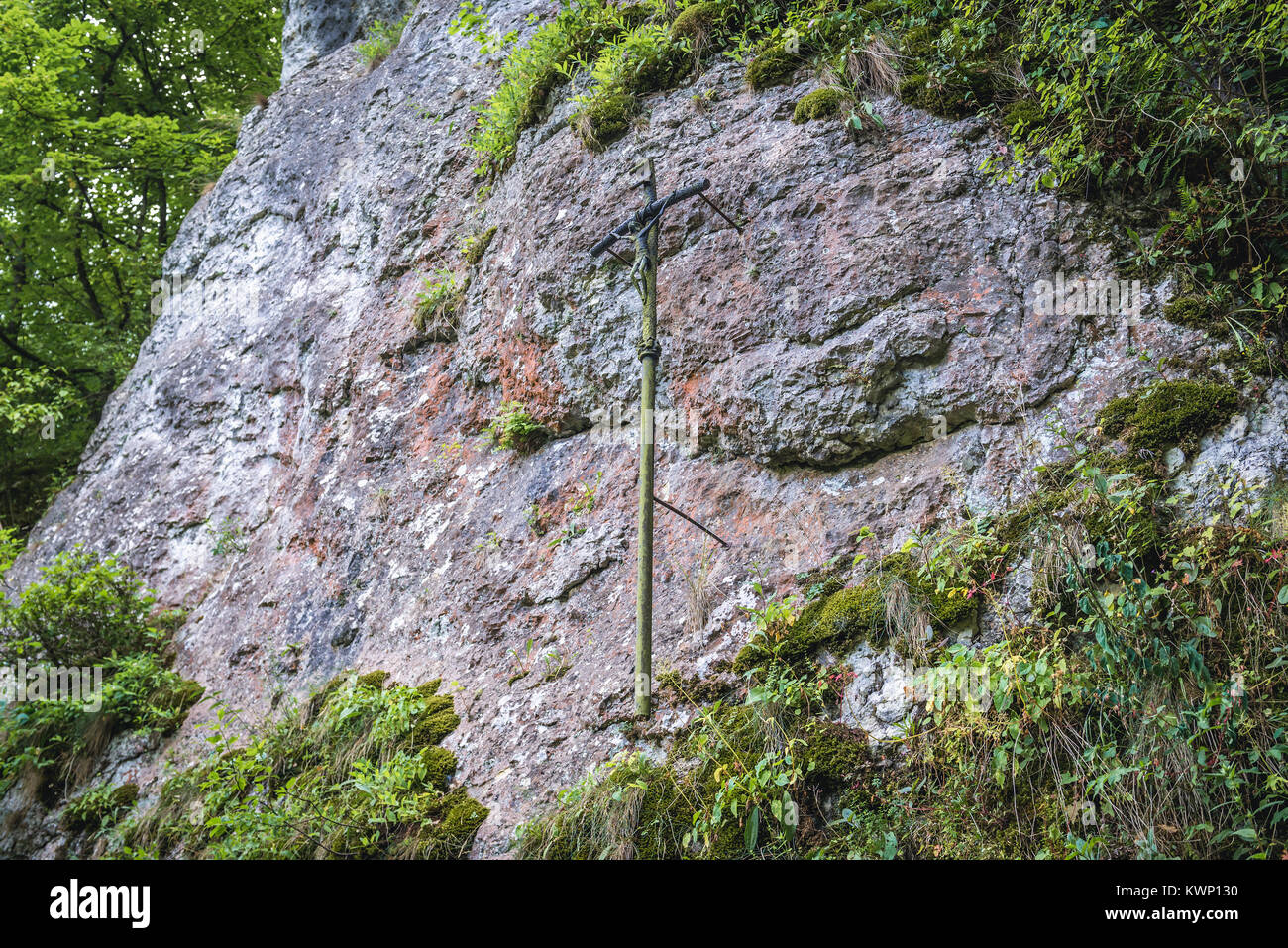 Cross next to Our Lady painting on the rock in Mnikowska Valley nature reserve in Lesser Poland Voivodeship in Poland Stock Photo