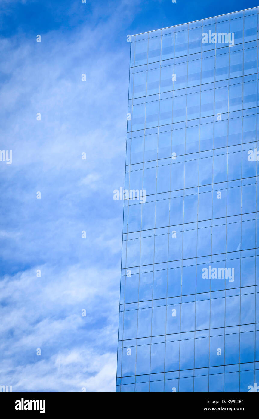 Glass clad office building reflecting the sky and clouds Stock Photo ...