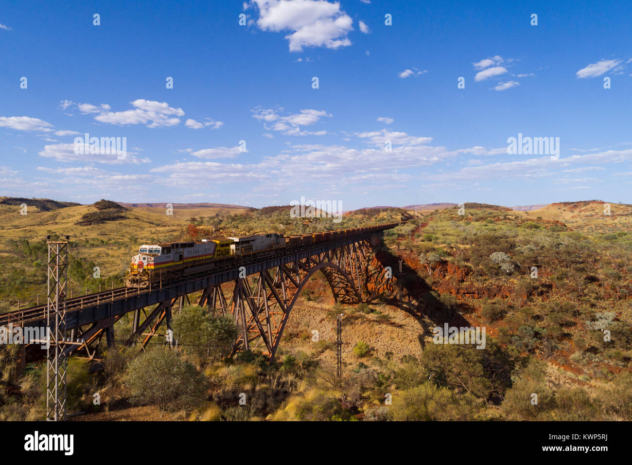 Iron Ore train crossing over the largest privately owned single span railway bridge in the southern hemisphere, Pilbara, Western Australia Stock Photo