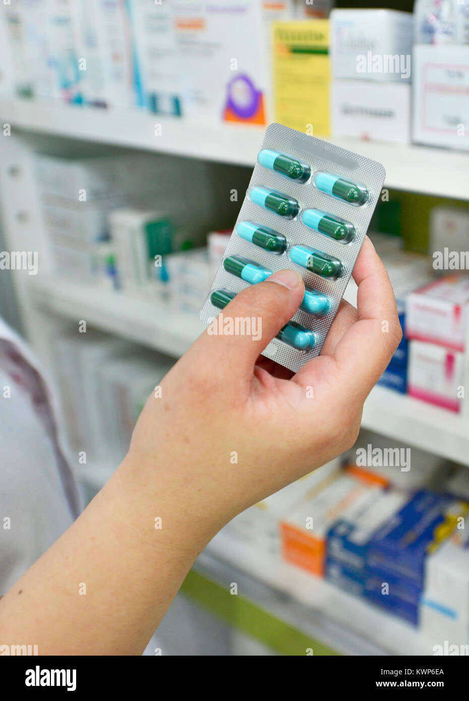 Hand holding medicine capsule pack at the pharmacy drugstore Stock