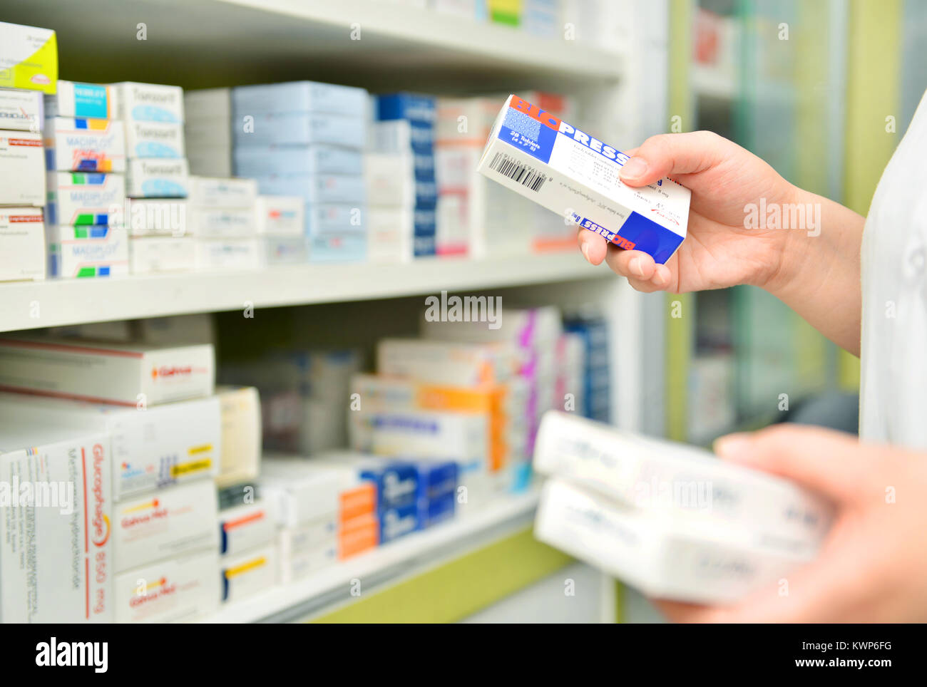 Pharmacist holding medicine box in pharmacy drugstore Stock Photo - Alamy