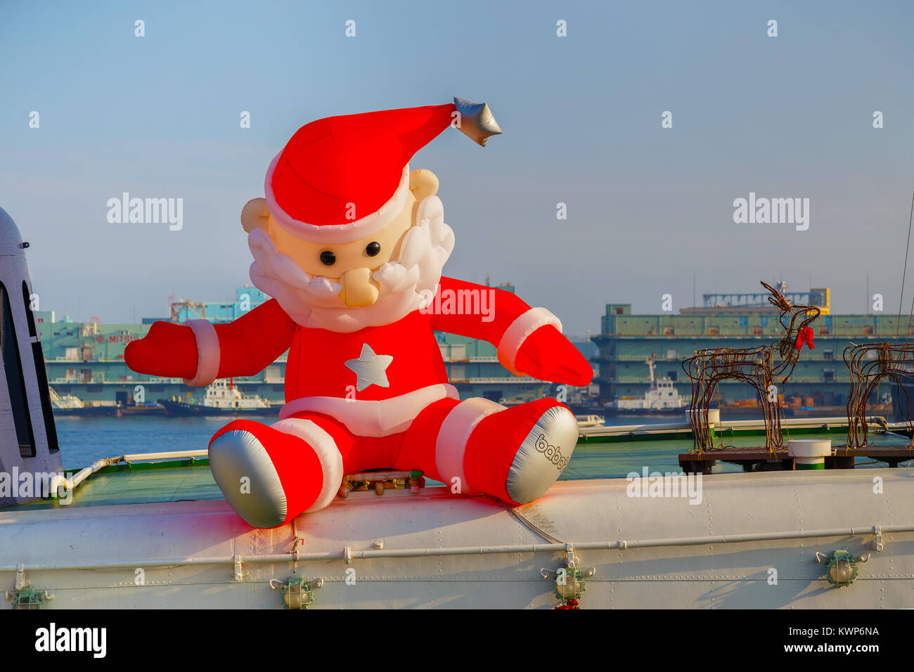 YOKOHAMA, JAPAN - NOVEMBER 24 2015: Inflatable santa claus doll on the top deck of a ship at Yokohama port Stock Photo