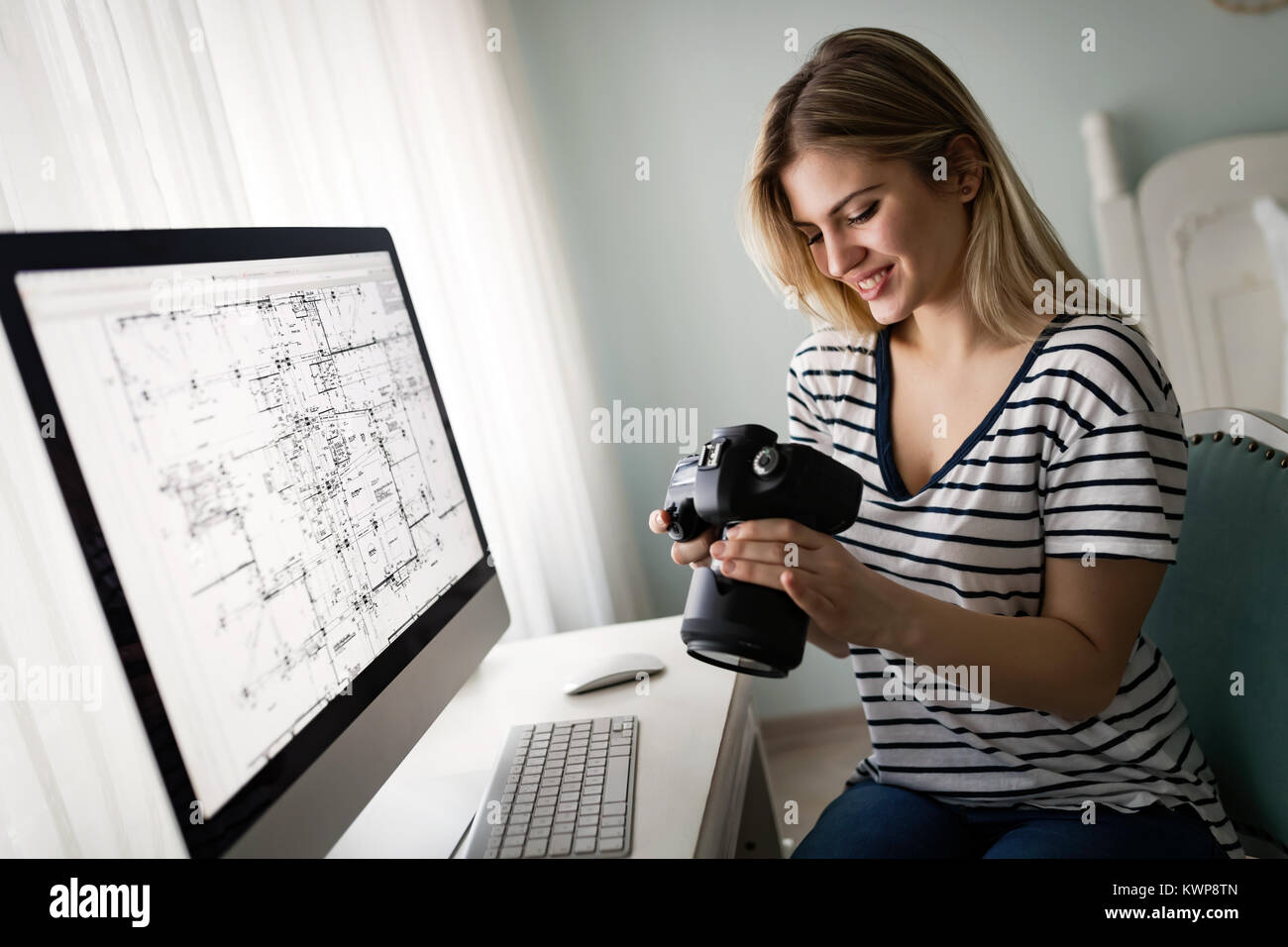 Portrait of young woman designing at home Stock Photo