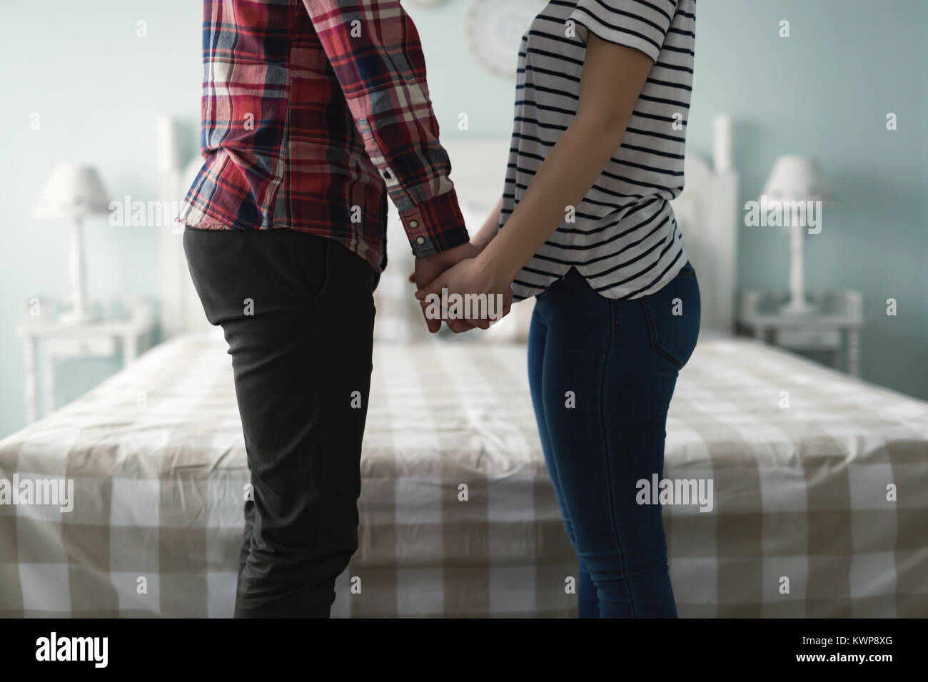 Portrait of man and woman in bedroom Stock Photo