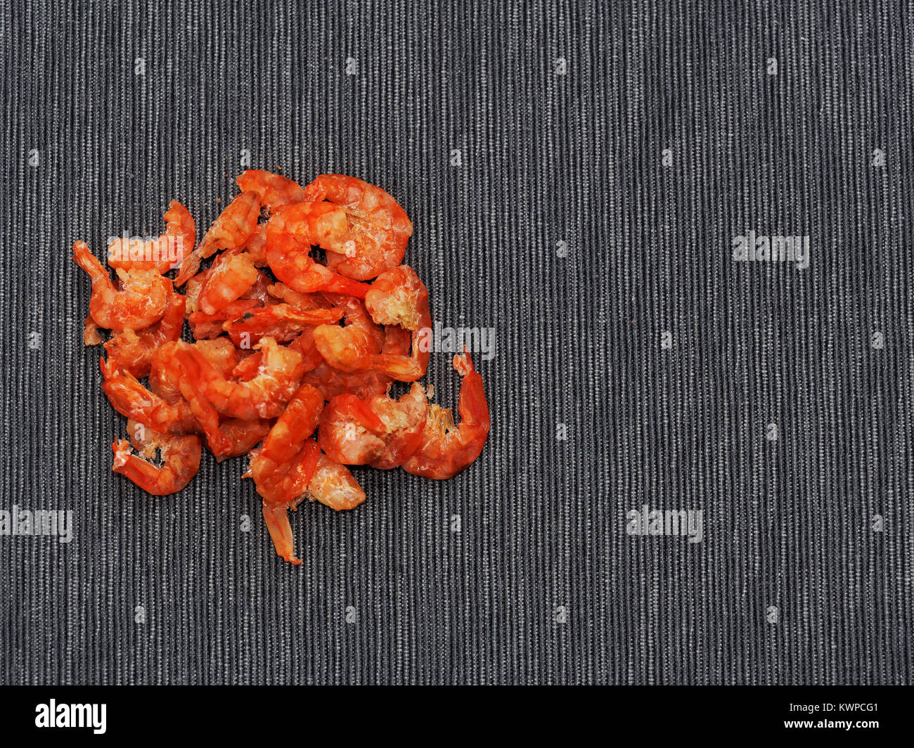 Dried shrimp or prawn isolated on dark linen background used as