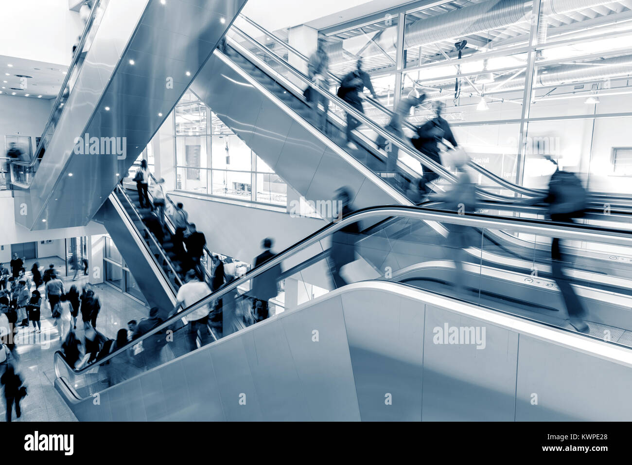 Business People rushing through on a escalator Stock Photo - Alamy