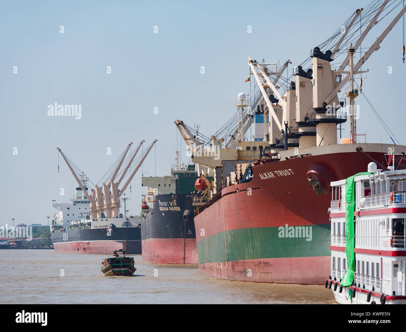Traditional, wooden cargo vessel on Yangon River next to one of Yangonâ€™s main commercial ports. Stock Photo