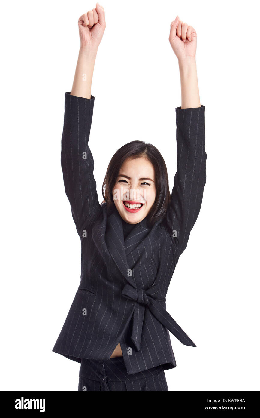 studio shot of a young asian business woman celebrating success, arms up, isolated on white background. Stock Photo