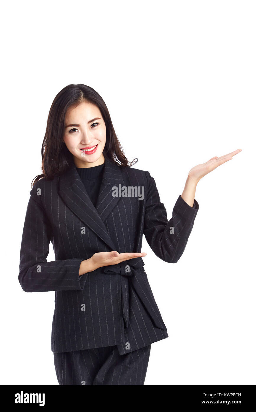 studio shot of a young and beautiful asian business woman making an introduction, isolated on white background. Stock Photo