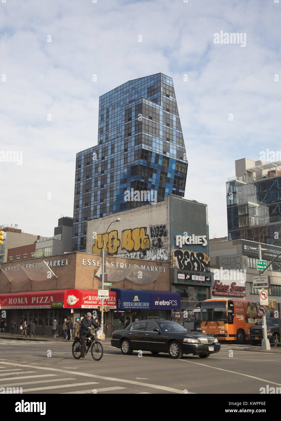 The changing face of the Lower East Side as seen from the corner of Delancey and Essex streets in Manhattan, New York City. The now famous Bernard Tschumi’s  residential blue building at Norfolk and Delancey Streets shoots up in the background. Stock Photo