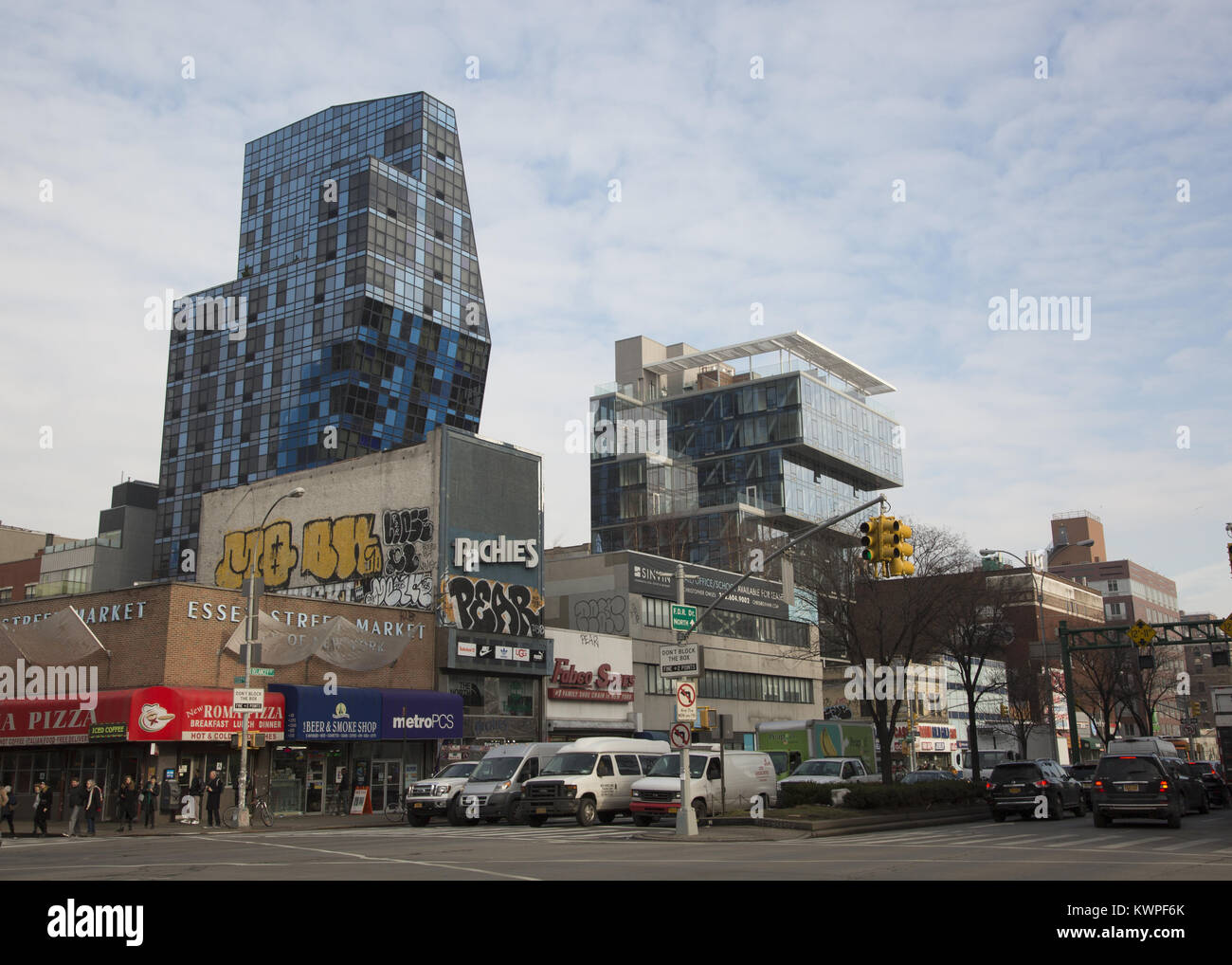 The changing face of the Lower East Side as seen from the corner of Delancey and Essex streets in Manhattan, New York City. The now famous Bernard Tschumi’s  residential blue building at Norfolk and Delancey Streets shoots up in the background. Stock Photo