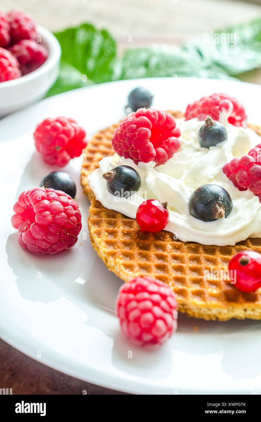 Belgian waffles with whipped cream and fresh berries Stock Photo - Alamy