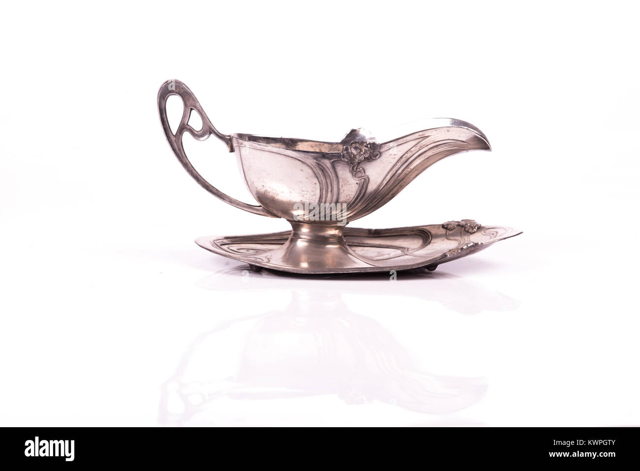 handcrafted art nouveau silver cup sauce over a white background Stock Photo