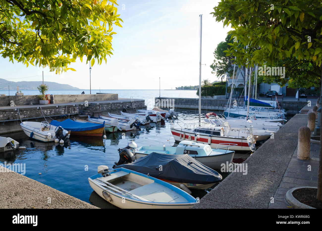 GARGNANO, LAKE GARDA, ITALY. 24th October 2017. Small boats lying moored up for the Autumn in the little harbour at the lakeside village of Gargagno, Stock Photo