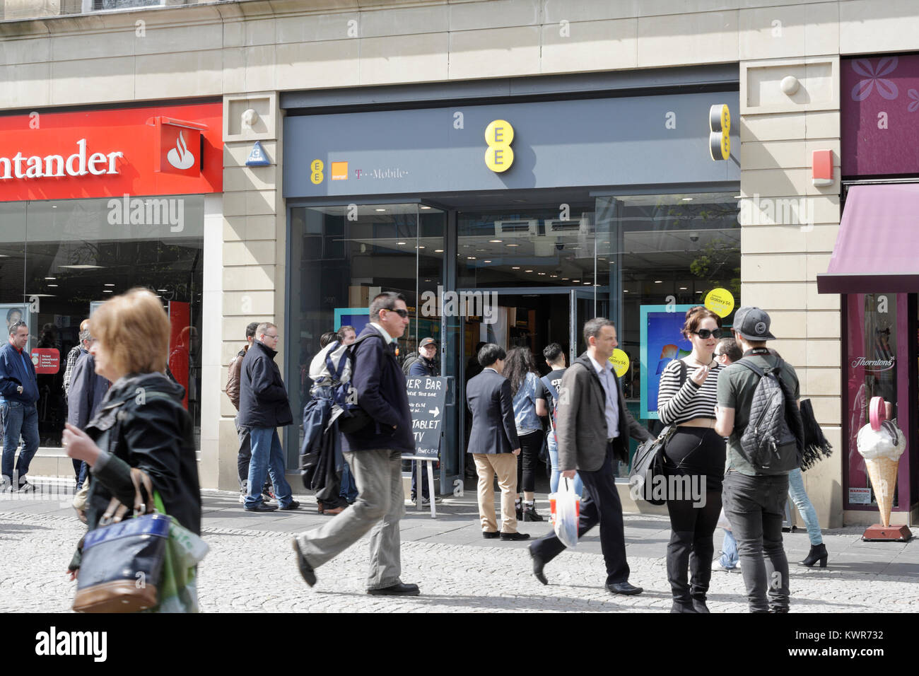 Shoppers walking past EE shop, Fargate Sheffield city centre UK Stock Photo