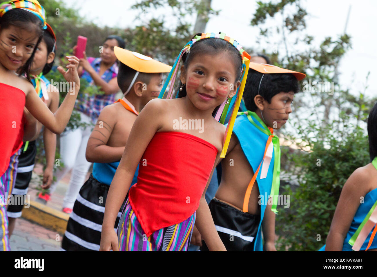 Street child; Local Galapagos children in a street parade, Puerto Ayora, Santa Cruz island, galapagos Islands, Ecuador South America Stock Photo