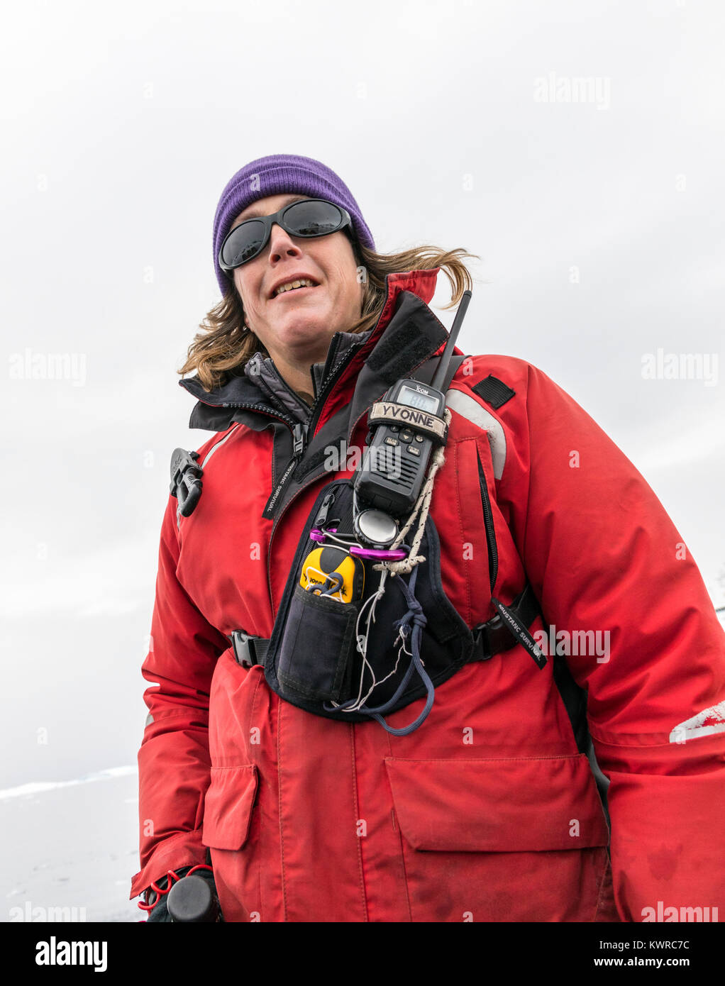 Naturalist & professional guide drives large inflatable Zodiac boats shuttle alpine mountaineering skiers to Antarctica from the passenger ship Ocean  Stock Photo