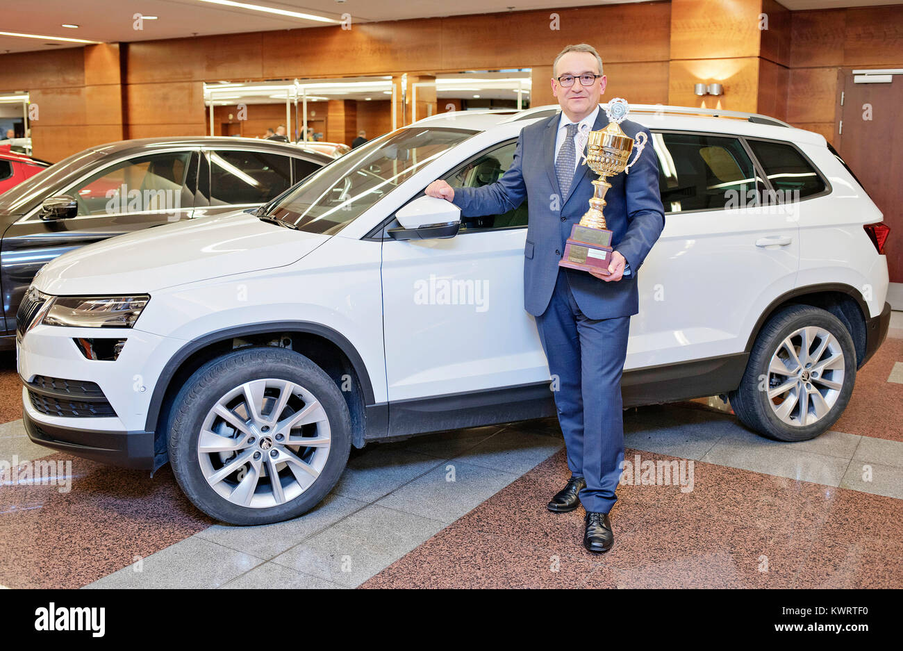 Prague, Czech Republic. 05th Jan, 2018. The head of Skoda's sales organisation for the Czech Republic Lubos Vlcek presents the trophy as the Skoda Karoq has won the Car of the Year 2018 title in the Czech Republic, beating the BMW 5 Series, Opel Insignia, Kia Stinger and Subaru Impreza in the competition today, on Friday, January 5, 2018. Credit: Rene Fluger/CTK Photo/Alamy Live News Stock Photo