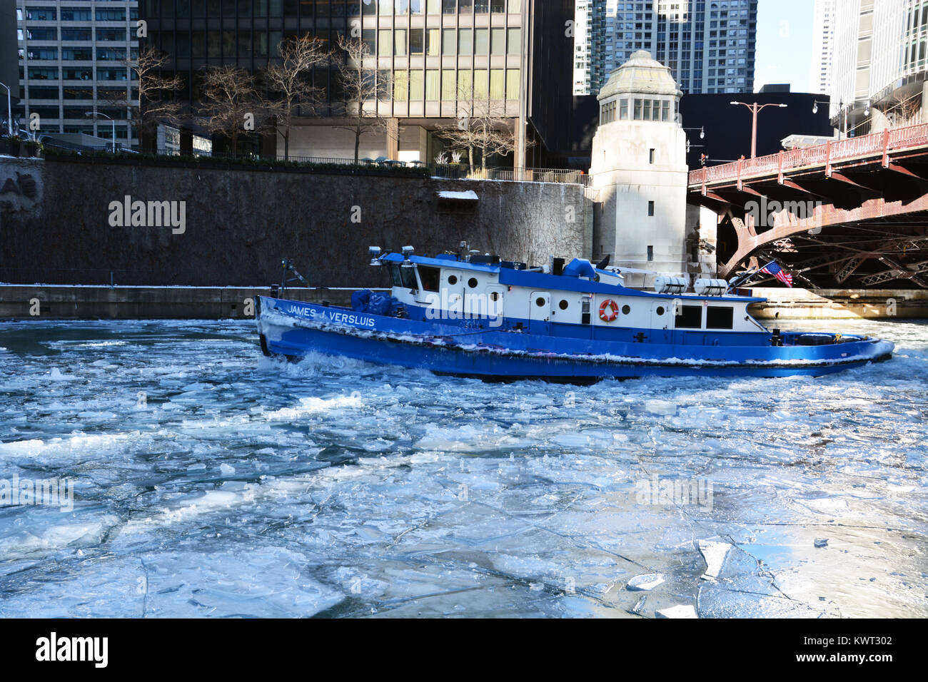a tugboat works to break up ice on the river to keep it open to chicago ice works