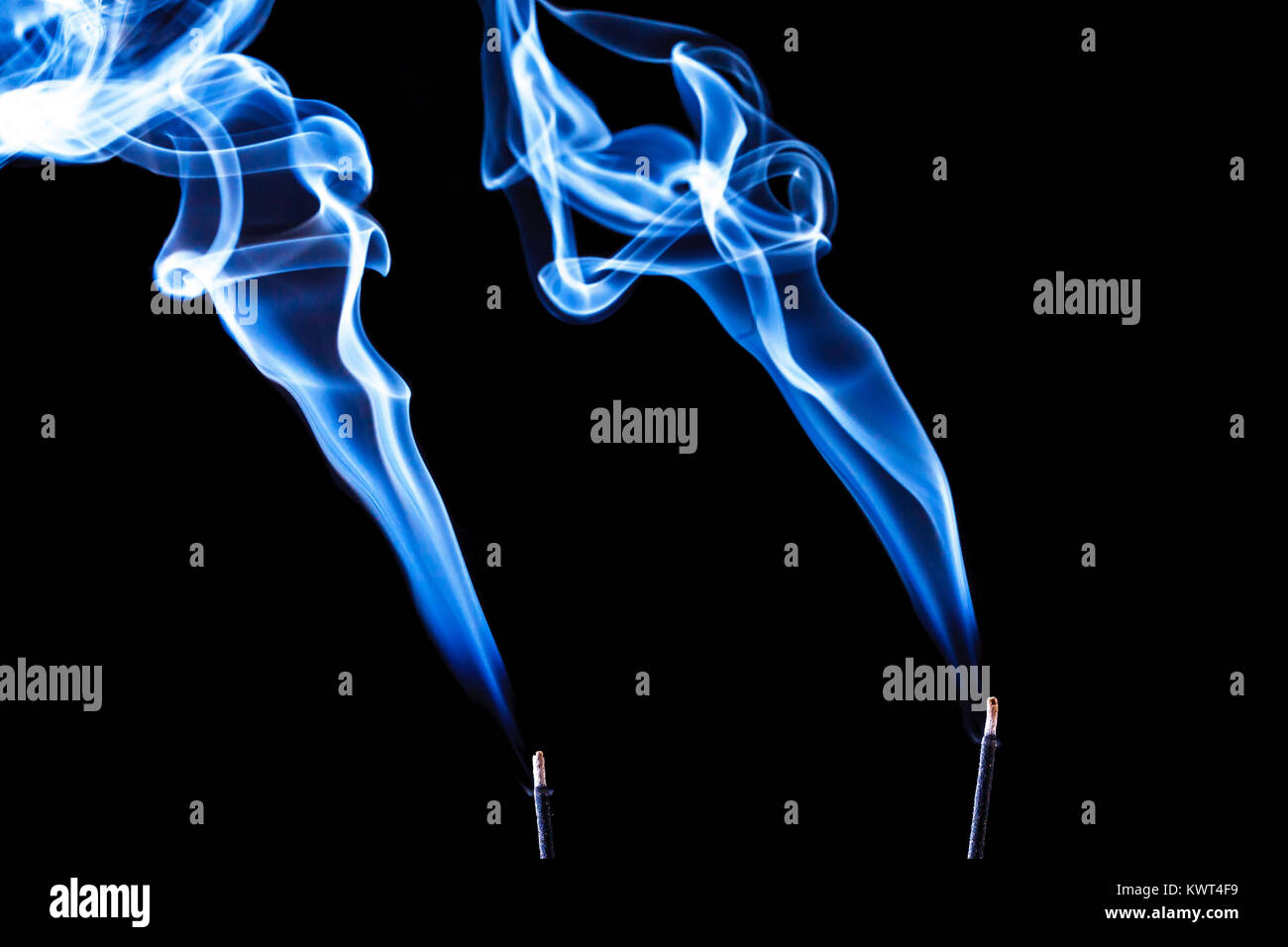 Conceptual image of trails of blue incense smoke making interest shapes