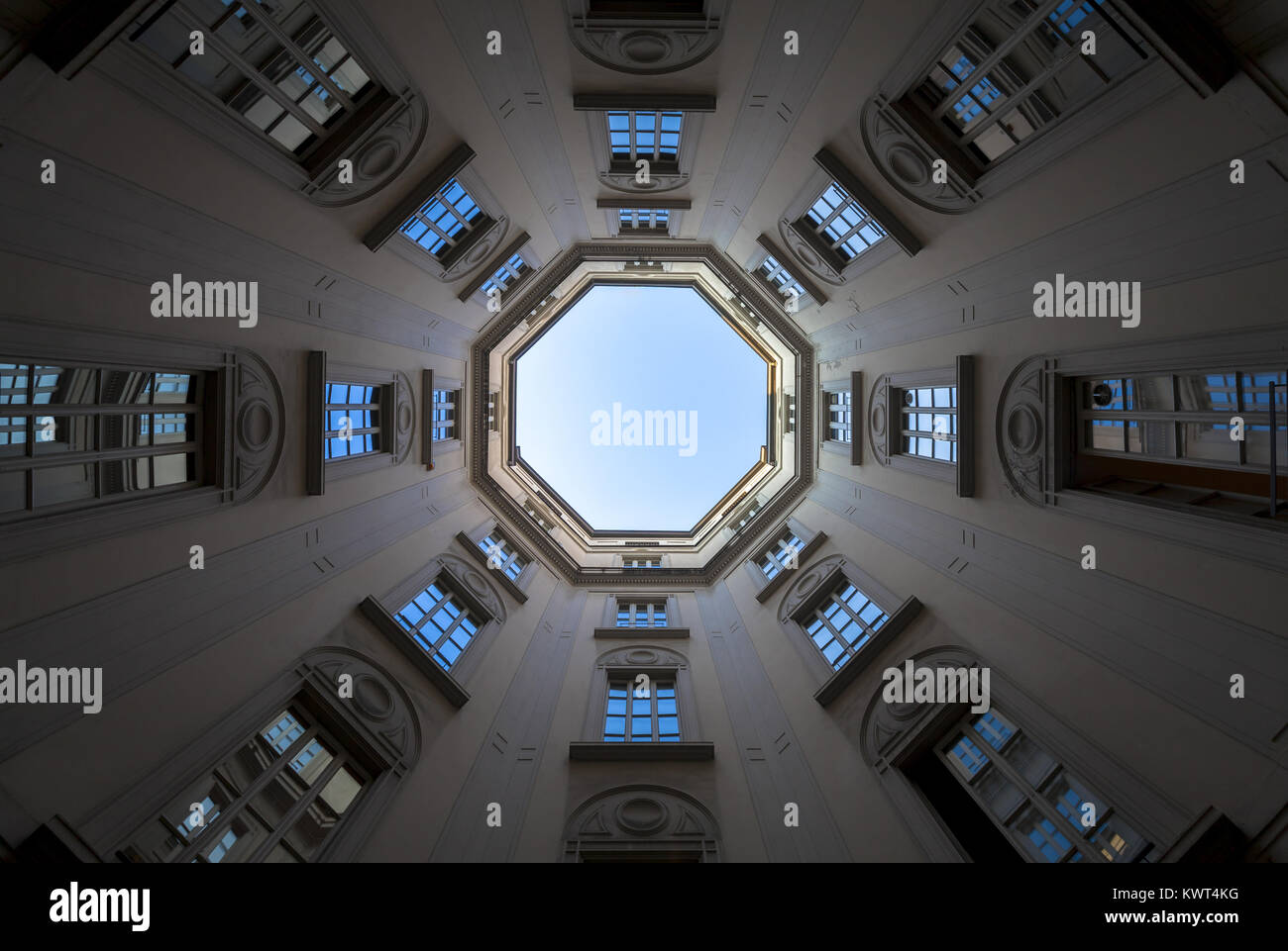 Italy, Milan. Interior of an old palace, looking to the sky with a wide 16mm lens. Stock Photo