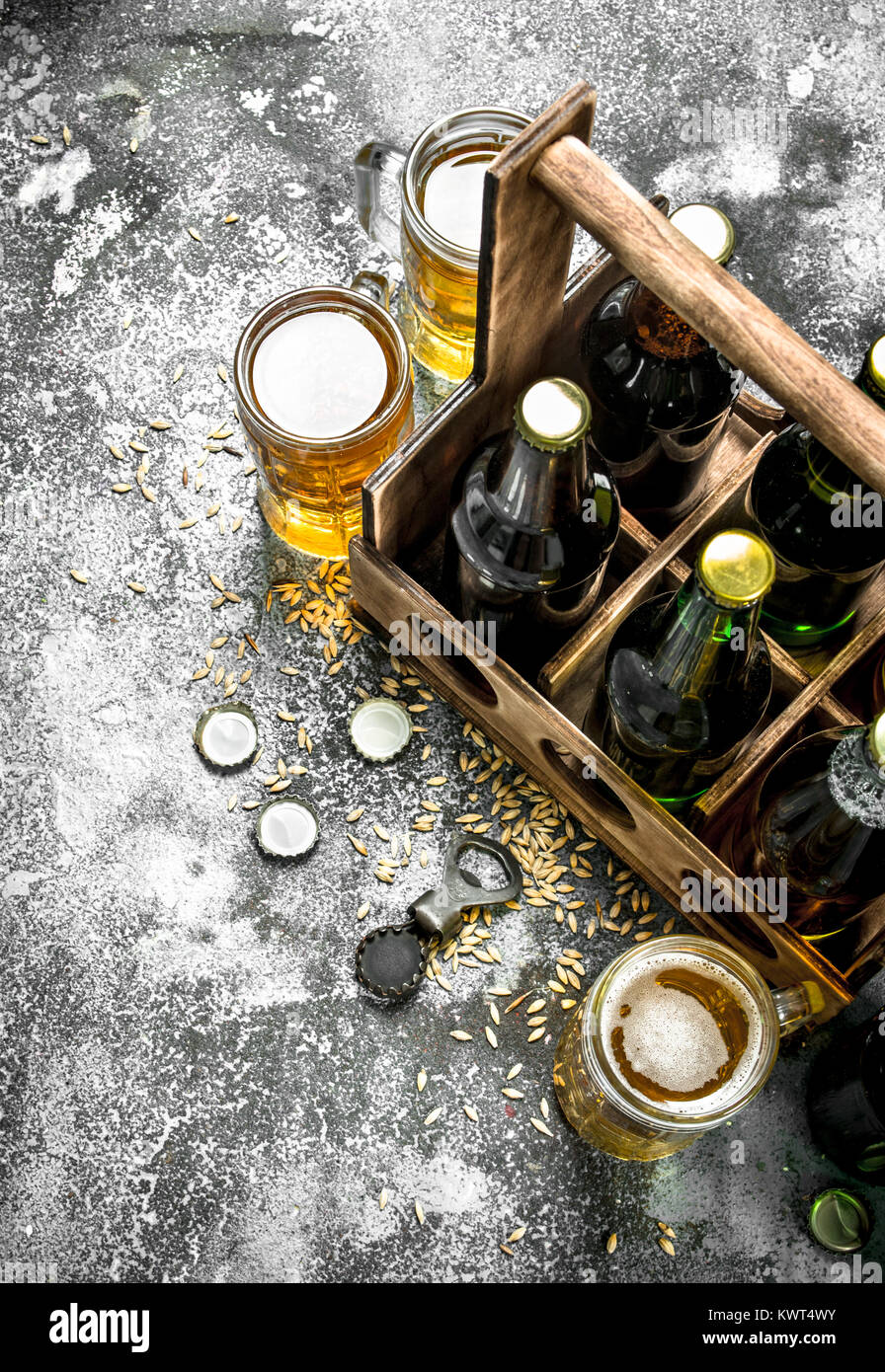 Beer background. Fresh beer in glasses and an old box. On a rustic ...