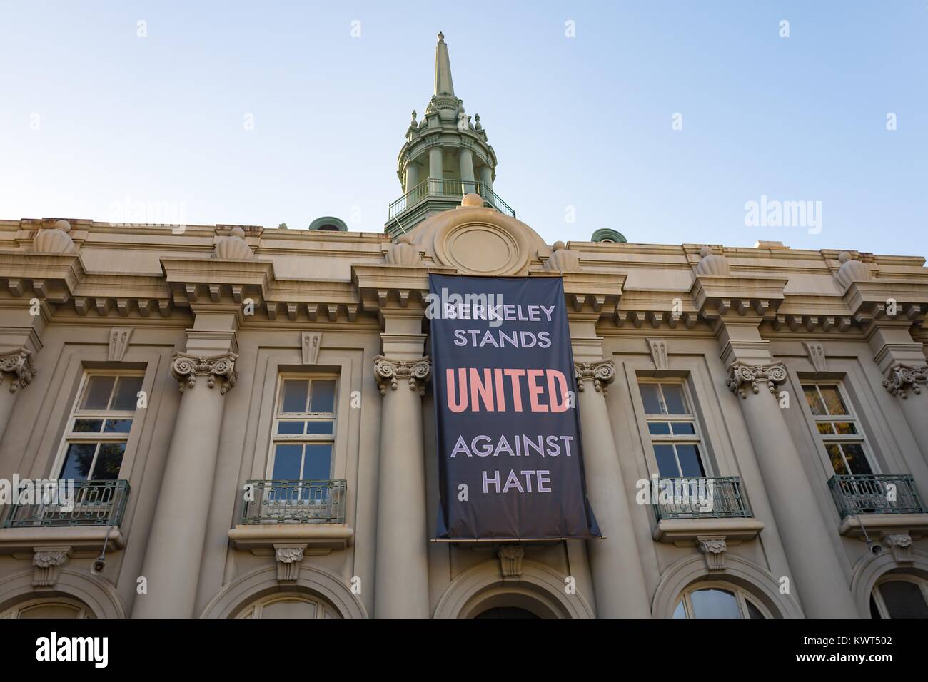 A large banner reading 'Berkeley Stands United Against Hate' hands on the Maudelle Shirek Building (aka Old City Hall) at Martin Luther King Jr Civic Center Park in Berkeley, California, part of a city-led response to 'alt right' organizations' 'anti Marxist' protests in the city, October 6, 2017. () Stock Photo