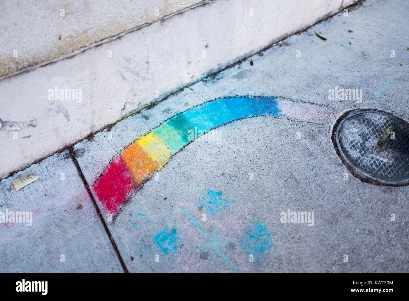 In the Gourmet Ghetto (North Shattuck) neighborhood of Berkeley, California, someone has used sidewalk chalk to draw a rainbow on the sidewalk, a symbol both of the hippie movement and of LGBT rights, October 6, 2017. () Stock Photo