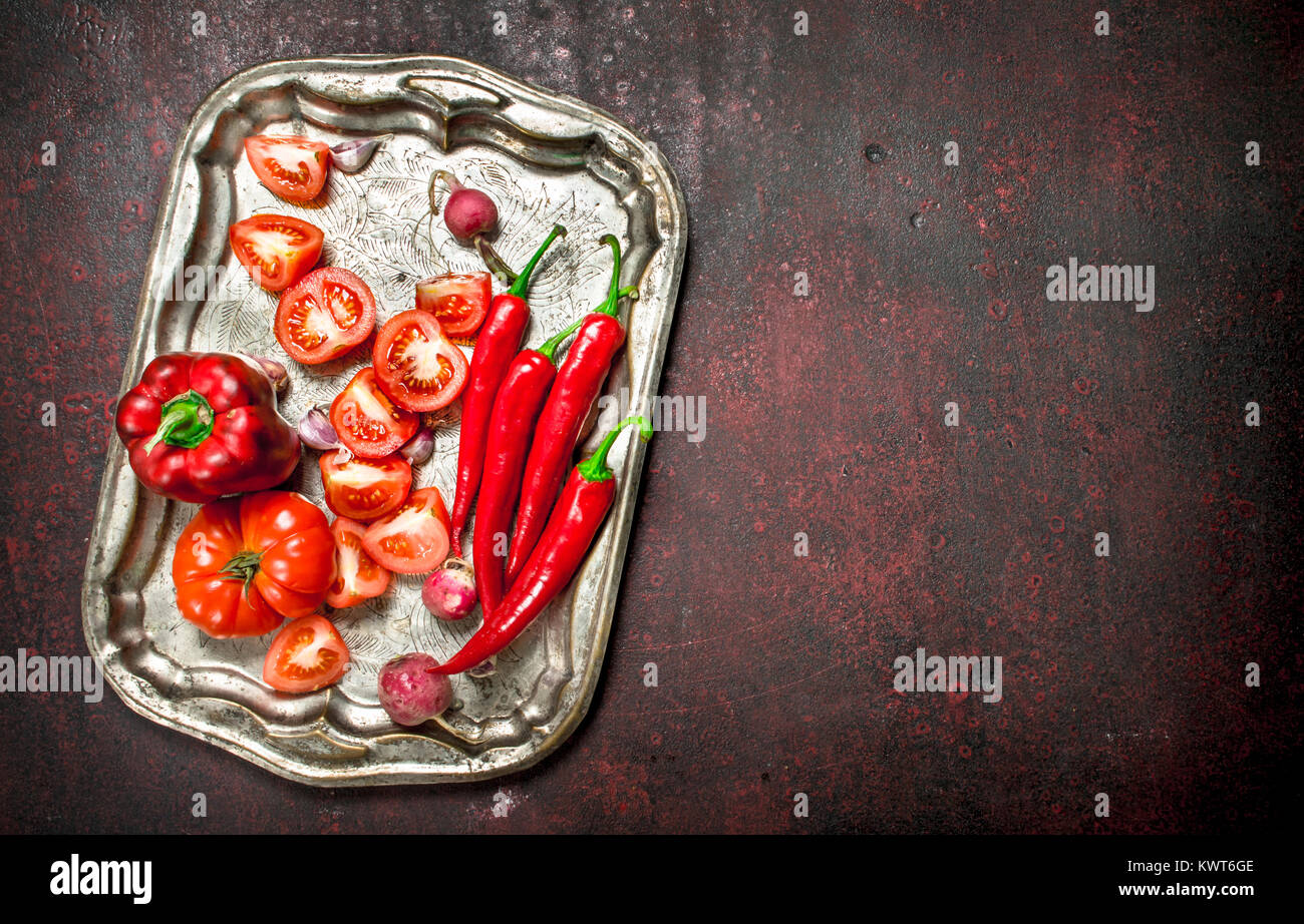 Red organic food. Fresh hot chili pepper, tomatoes and sweet pepper on ...