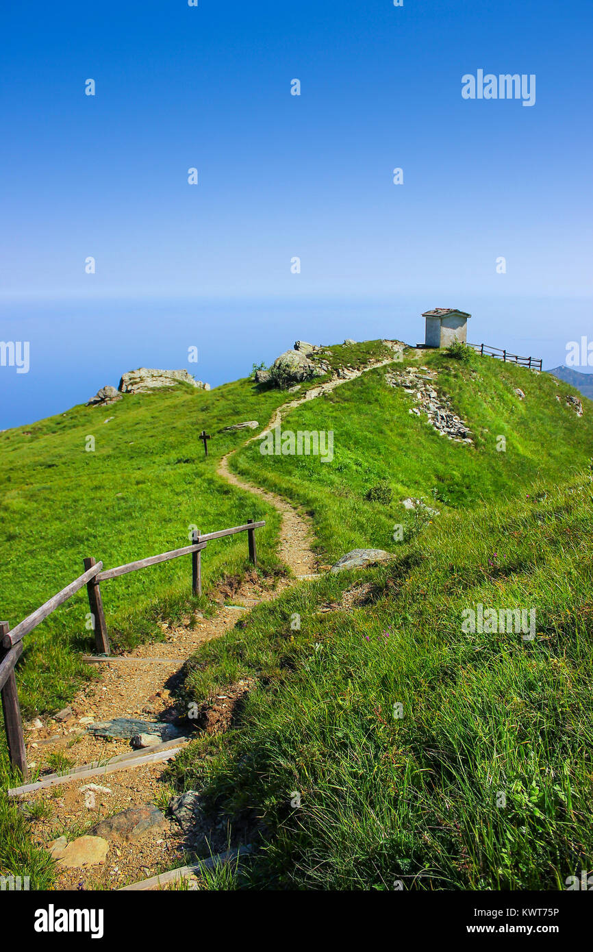 Alpine landscape with small soldiers monument facing the Mediteranean Sea in Beigua National Geopark, Liguria, Italy Stock Photo